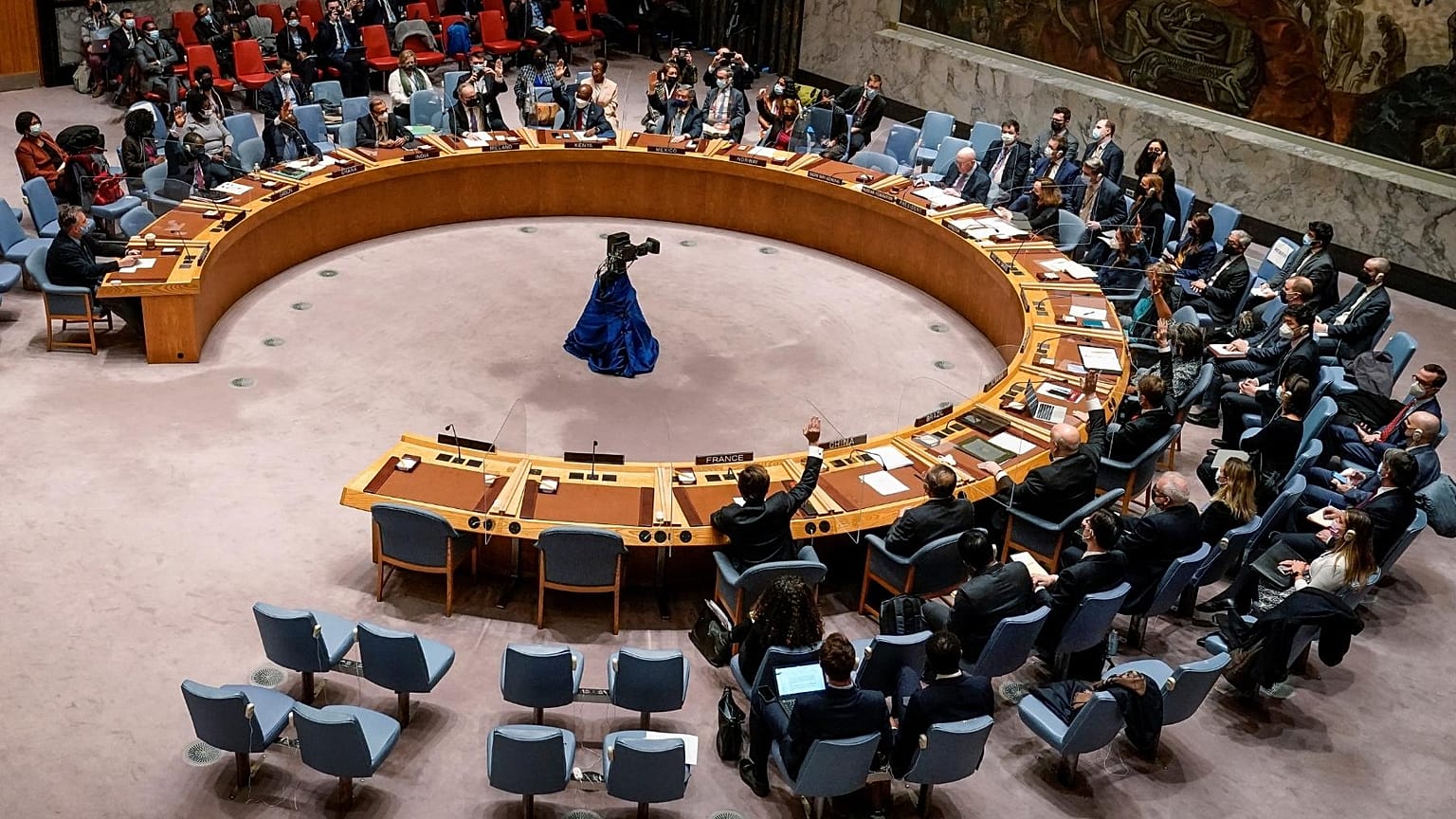 AP PFILE - Representatives voting in favor of a resolution raise their hands during a UN Security Council meeting on the Russian invasion of the Ukraine, 25 February, 2022