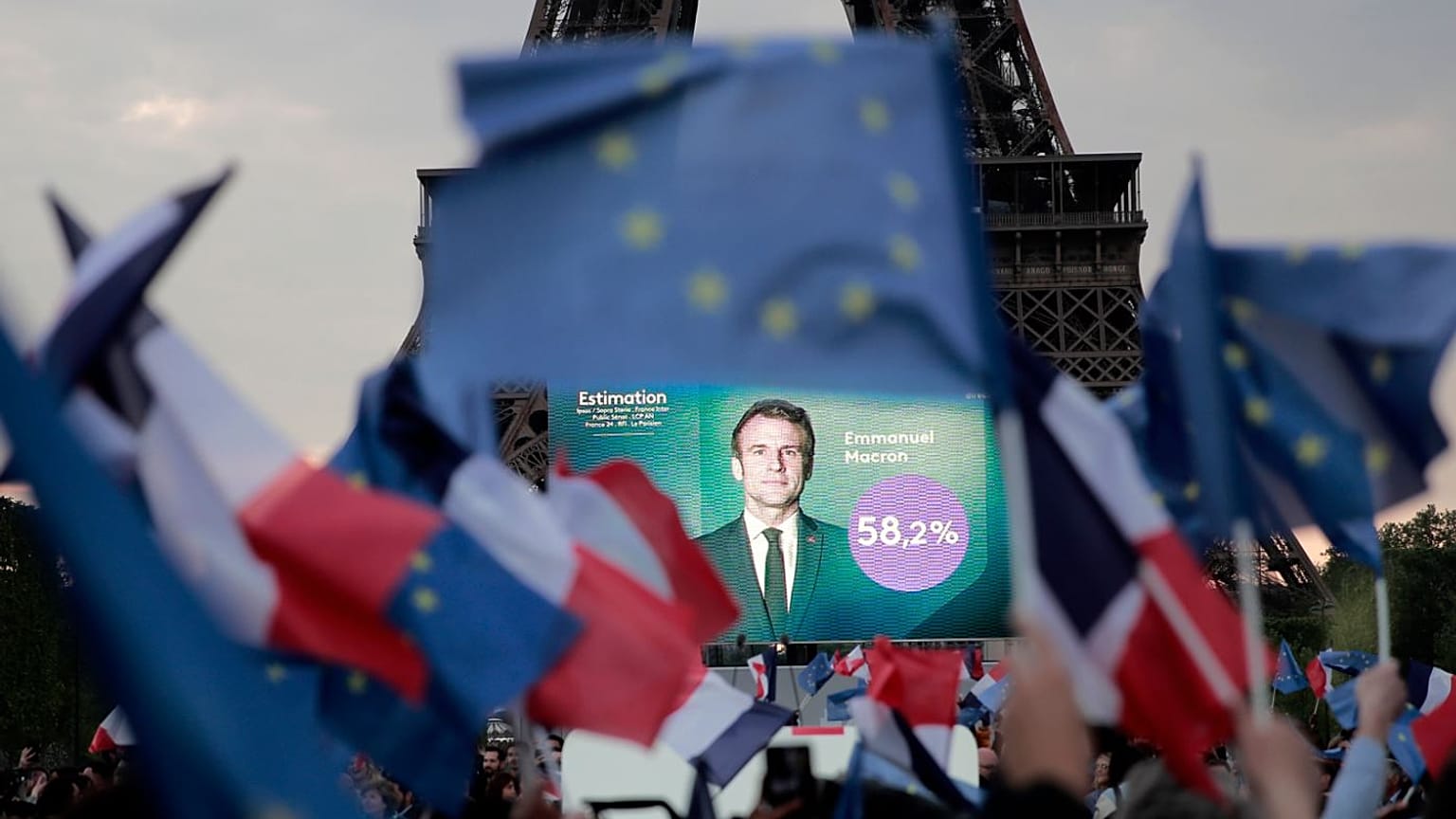 Supporters of French President Emmanuel Macron celebrate in front of the Eiffel Tower.
