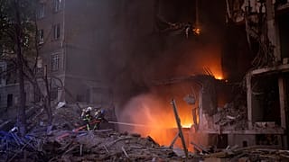 Firefighters try to put out a fire following an explosion in Kyiv on 28 April 2022