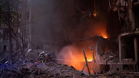 Firefighters try to put out a fire following an explosion in Kyiv on 28 April 2022
