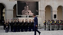French President Emmanuel Macron walks during a national homage to late French actor Michel Bouquet