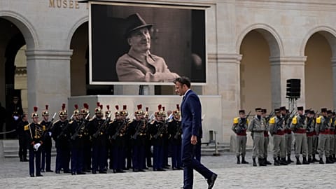 French President Emmanuel Macron walks during a national homage to late French actor Michel Bouquet