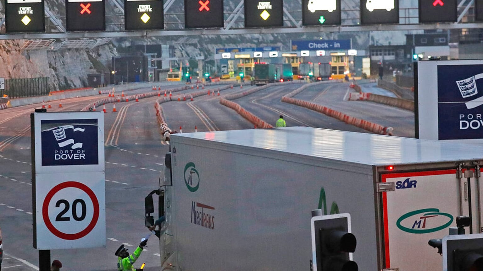 Thursday, Dec. 31, 2020, lorries pass a checkpoint to embark by ferry to Europe, at the port in Dover, England.