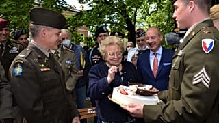 The cake was presented to 90-year-old Meri Mion by soldiers from US Army Garrison Italy.