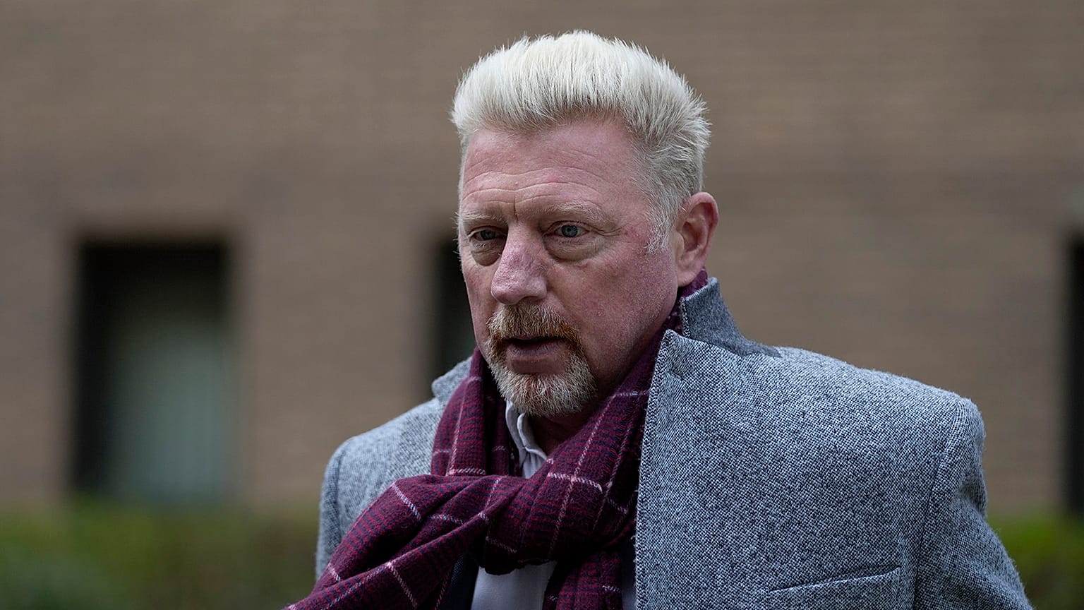 Former tennis player Boris Becker, right, leaves Southwark Crown Court in London on 7 April 2022