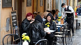People gather at a bar in Rome, Sunday, May 1, 2022.