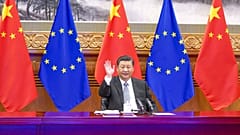 Chinese President Xi Jinping waves during a video conference with European leaders from Beijing on Wednesday, Dec. 30, 2020. 