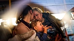 People with children wait after arriving from the Ukrainian city of Mariupol at a center for displaced people in Zaporizhzhia, Ukraine, Tuesday, May 3, 2022