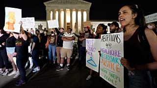 A crowd of people gather outside the Supreme Court, early Tuesday, May 3, 2022 in Washington.