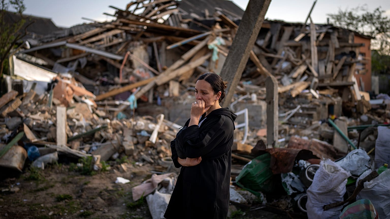Woman surveys wreckage of her home in Irpin, near Kyiv in Ukraine