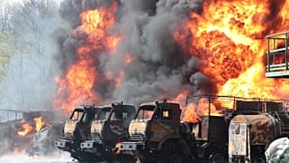 Vehicles are on fire at an oil depot after missiles struck the facility in an area controlled by Russian-backed separatist forces in Makiivka, 15 km east of Donetsk