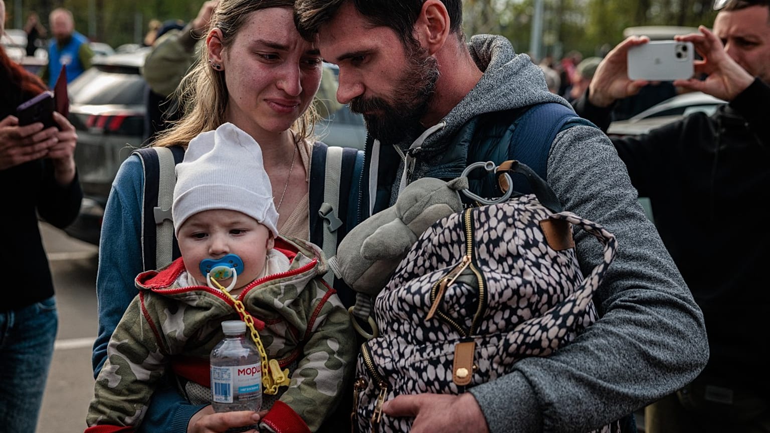 A man welcomes Anna Zaitseva and her son Svyatoslav, 6 month old, after arriving from Mariupol at a reception centre in Zaporizhzhia on May 3, 2022. 