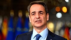 Greek Prime Minister Kyriakos Mitsotakis speaks with the media at the European Council in Brussels.