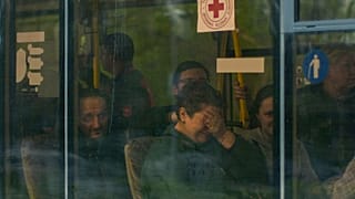 From left, Serhii Tsybulchenko, Ihor Trotsak, Tetyana Trotsak and Elina Tsybulchenko, who fled from the steel plant in Mariupol, Ukraine, arrive by bus in Zaporizhzhia, 3 May.