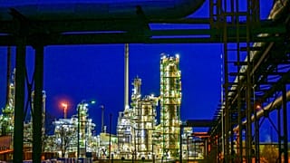 The facilities of the oil refinery on the industrial site of PCK-Raffinerie GmbH are illuminated in the evening in Schwedt, Germany, Wednesday, May 4, 2022