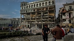 People watch the rescue effort at the site of a deadly explosion that destroyed the five-star Hotel Saratoga, in Havana, Cuba, Friday, May 6, 2022. 