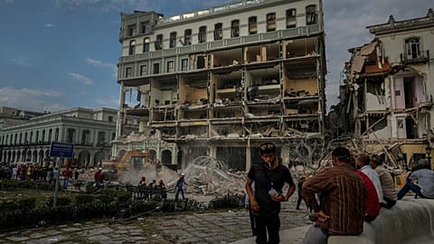 People watch the rescue effort at the site of a deadly explosion that destroyed the five-star Hotel Saratoga, in Havana, Cuba, Friday, May 6, 2022. 