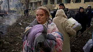 Marianna Vishegirskaya stands outside a maternity hospital that was damaged by shelling in Mariupol, Ukraine, Wednesday, March 9, 2022.