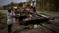 Maksym, 3, is photographed with his brother, Dmytro, 16, on top of a destroyed Russian tank, on the outskirts of Kyiv, Ukraine on Sunday, May 8, 2022.