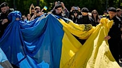 German police remove a huge Ukrainian flag from a Soviet War Memorial in Berlin on Sunday during commemorations to celebrate the end of World War II.
