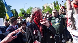 One protester threw a large amount of paint in Sergey Andreev's face.