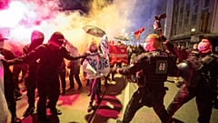Demonstrators take part in a rally against the curfews and coronavirus restrictions in Frankfurt/Main, Germany, Saturday, April 24, 2021.