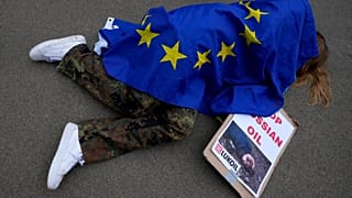 A protestor takes part in a demonstration to call on the European Union to stop buying Russian oil and gas, outside EU headquarters in Brussels, April 29, 2022.
