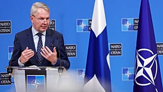 Ο υπουργός Εξωτερικών της Φινλανδίας με φόντο τη σημαία της χώρας του και του ΝΑΤΟ