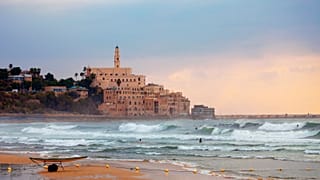 Surfers take to the water on Jaffa Beach, Tel Aviv.