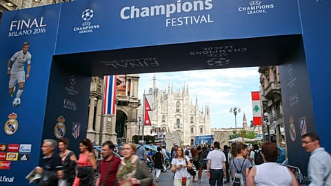 People walk by the Uefa Champions League fans zone near the Duomo gothic cathedral, in Milan, Italy, on May 25, 2016. 