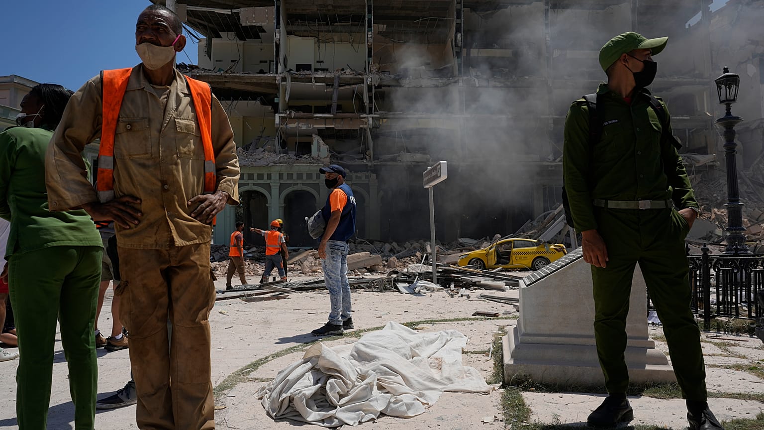 Un cuerpo cubierto con sábanas yace fuera del Hotel Saratoga de cinco estrellas después de una explosión mortal en La Habana Vieja, Cuba, el 6 de mayo de 2022. 