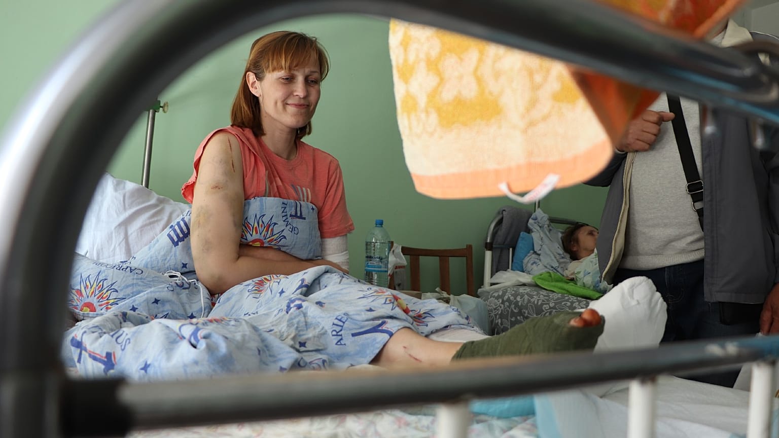 Natalia sits in her hospital bed. 
