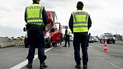 Austrian policemen check vehicles at the Hungarian border near Nickelsdorf.