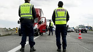 Austrian policemen check vehicles at the Hungarian border near Nickelsdorf.