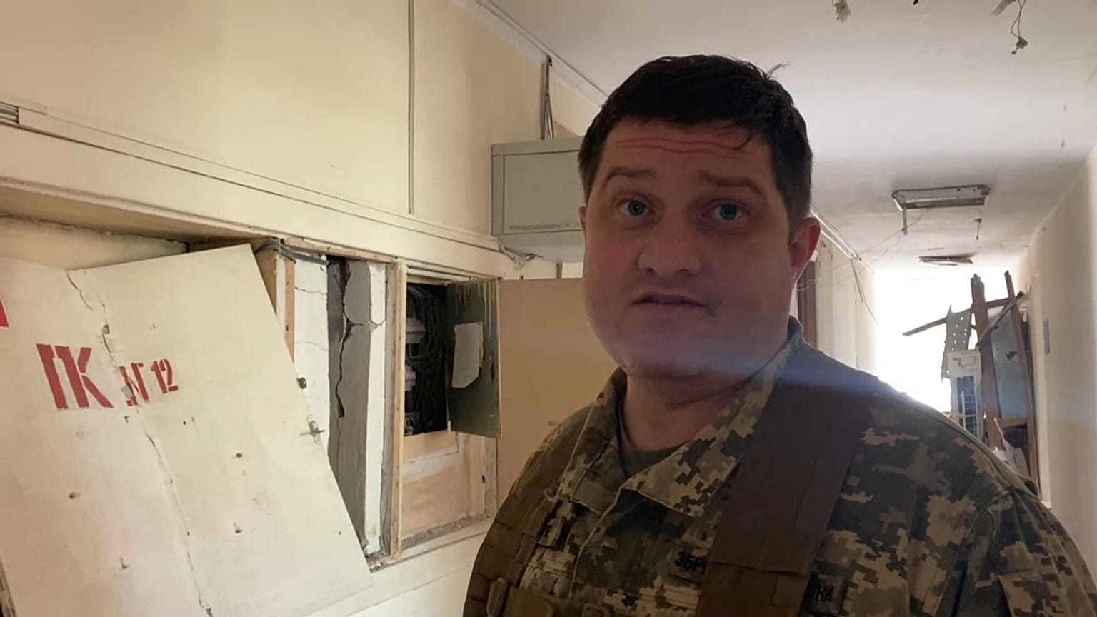 Dmytro Pletenchuk, a public affairs officer for the Mykolaiv regional government, in the remains of his workplace.  