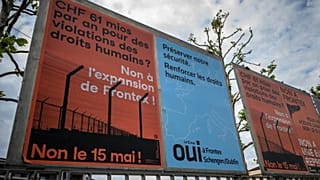 Electoral signs against and in favour of a referendum challenging plans to increase Switzerland’s contribution to the European border agency Frontex