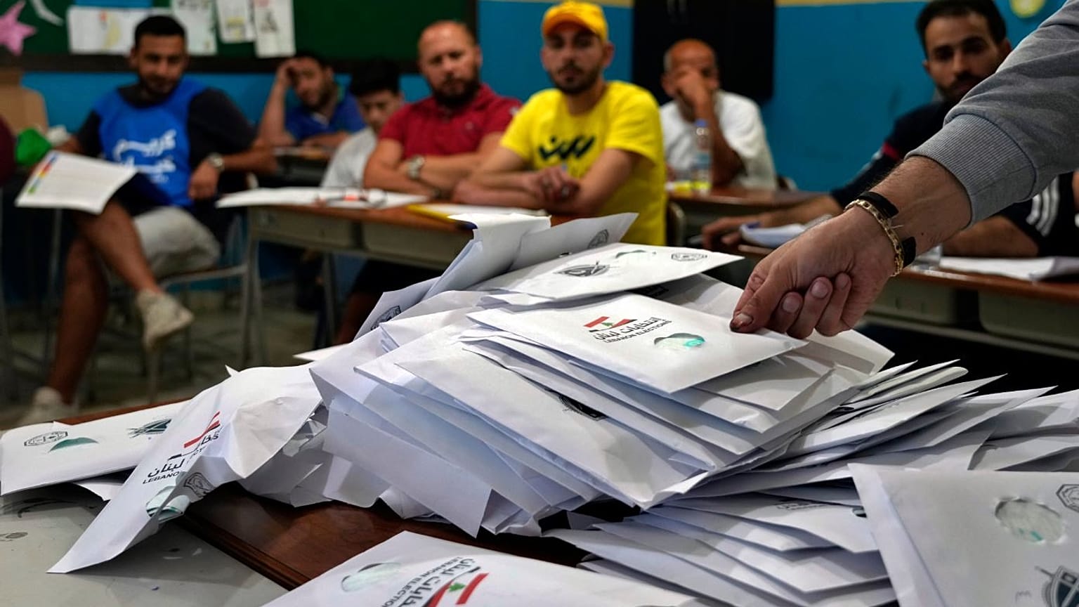 Election officials count ballots shortly after polling stations closed in the northern city of Tripoli.