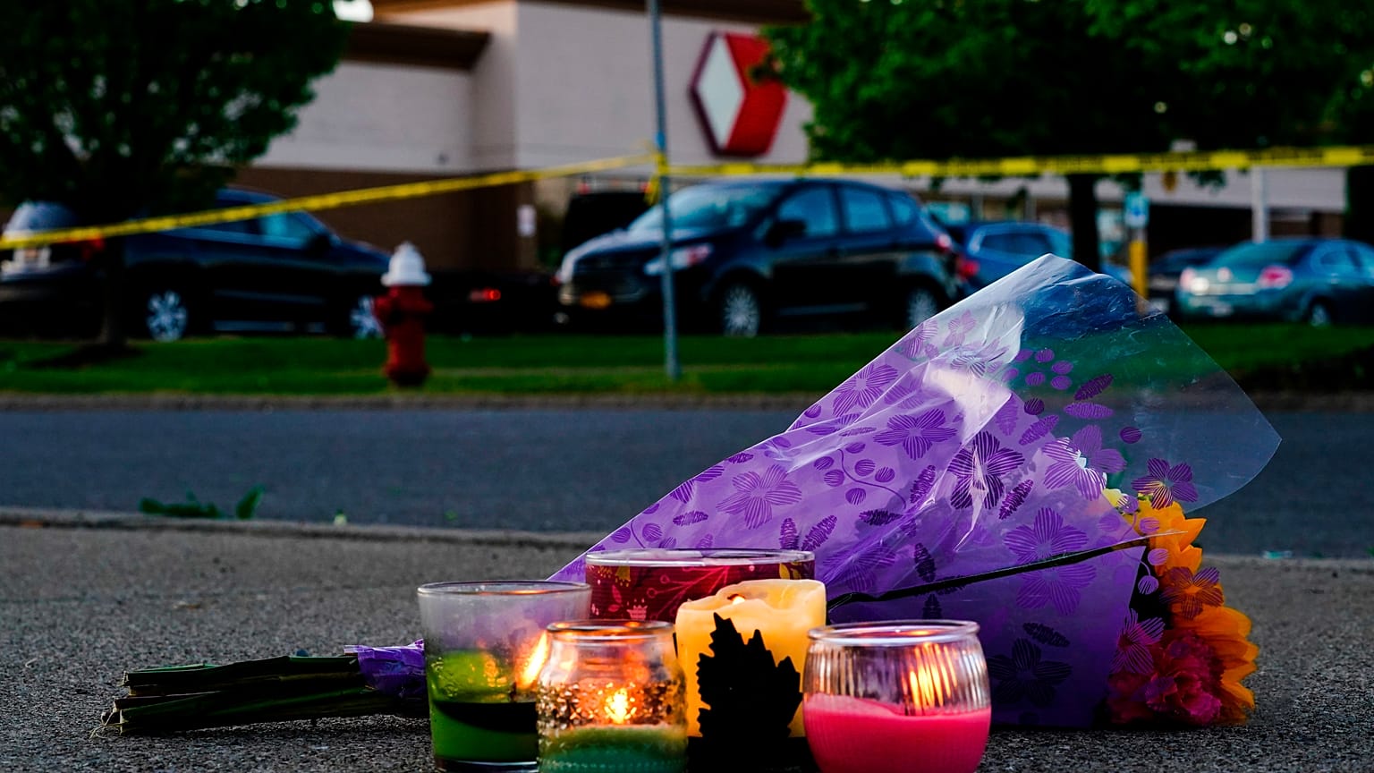 Flowers and candles lay outside the scene of a shooting at a supermarket in Buffalo.