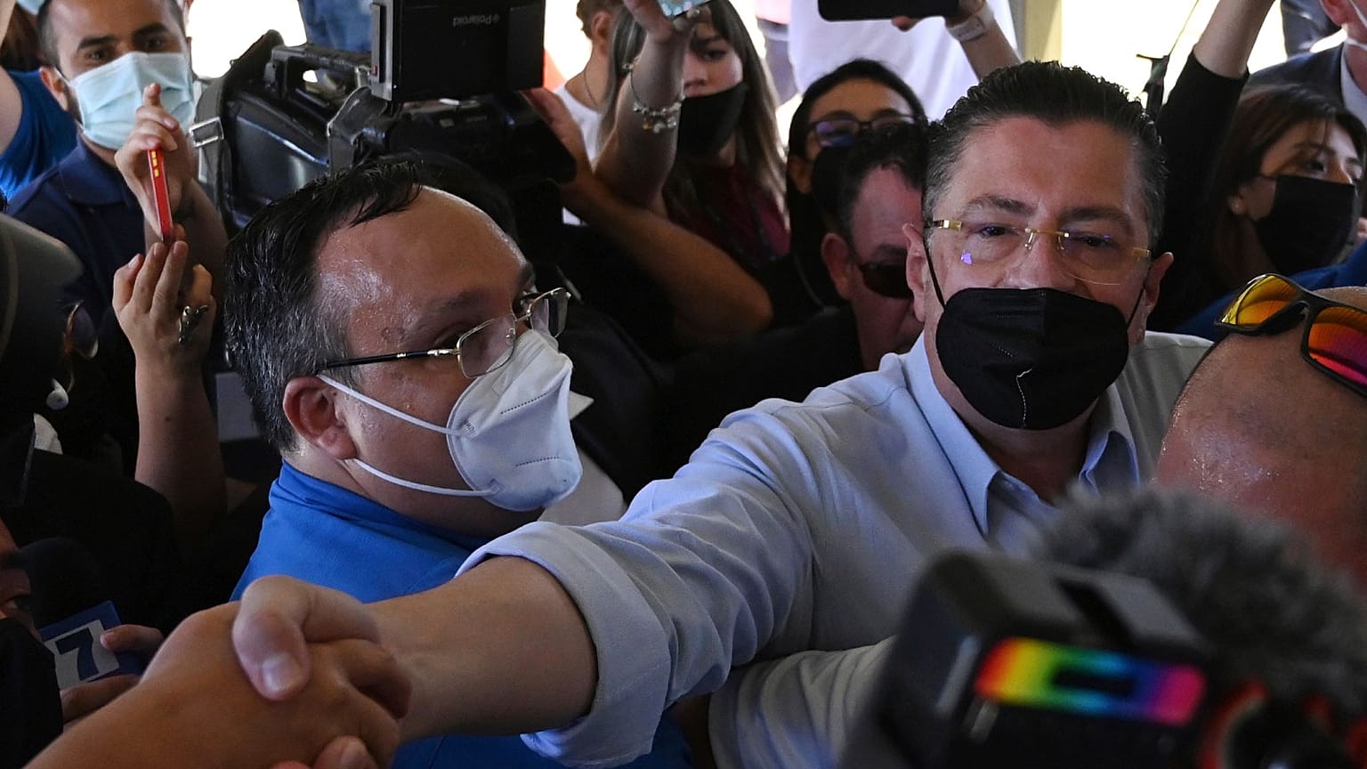 Presidential candidate Rodrigo Chaves greets supporters as he arrives to a polling station during a presidential runoff election in San Jose, Costa Rica, April 3, 2022.