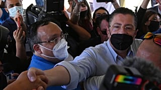 Presidential candidate Rodrigo Chaves greets supporters as he arrives to a polling station during a presidential runoff election in San Jose, Costa Rica, April 3, 2022.