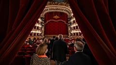 Spectators arrive at the Teatro San Carlo in Naples on April 27, 2022 to attend a show of Puccini's "Tosca".