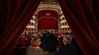 Spectators arrive at the Teatro San Carlo in Naples on April 27, 2022 to attend a show of Puccini's "Tosca".