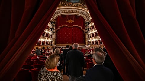Spectators arrive at the Teatro San Carlo in Naples on April 27, 2022 to attend a show of Puccini's "Tosca".