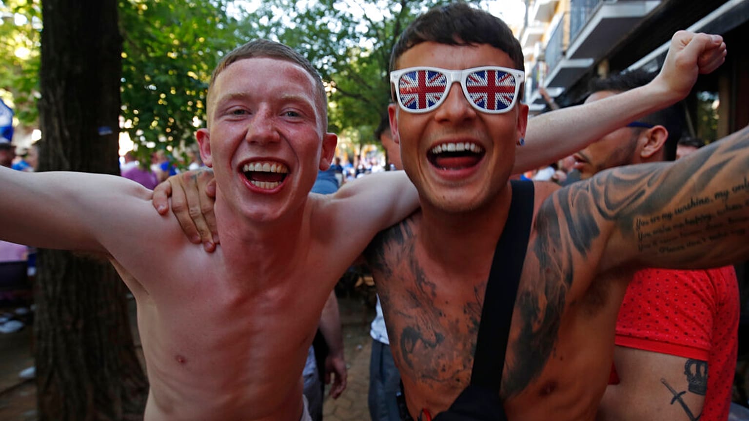 Glasgow Rangers supporters shout and cheer outside a bar in downtown Seville