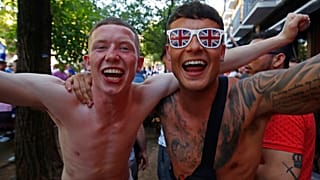 Glasgow Rangers supporters shout and cheer outside a bar in downtown Seville