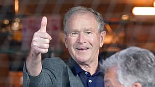 Former President George W. Bush gives a thumbs-up before a baseball game between the Atlanta Braves and the Texas Rangers in Arlington, Texas, Sunday, May 1, 2022.