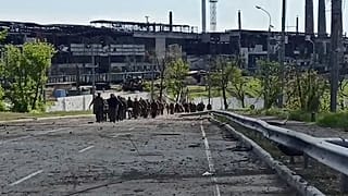 Ukrainian servicemen leave the besieged Azovstal steel plant in Mariupol, Ukraine, seen in a video from Russia's defence ministry released on May 18, 2022.