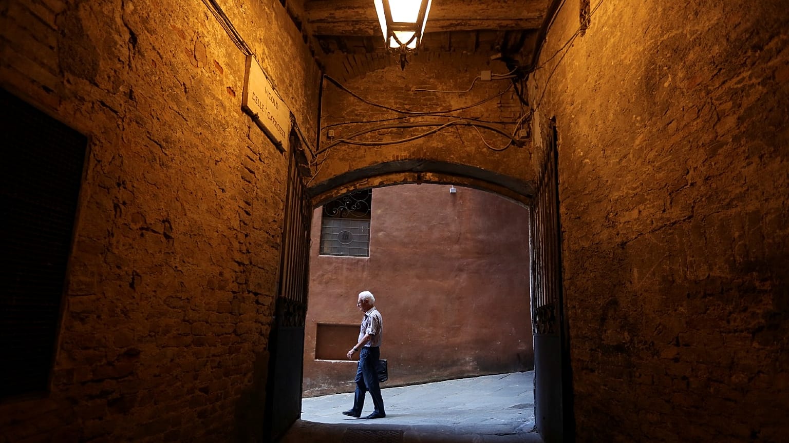 Stock picture of an elderly man walking in Siena, Italy. 