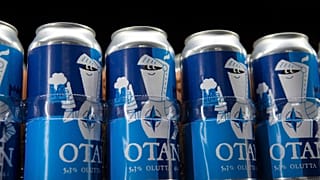 Beer cans with writing OTAN inspired by the North Atlantic Treaty Organization (NATO) logo by Olaf Brewing, in Savonlinna, eastern Finland, Tuesday, May 17, 2022