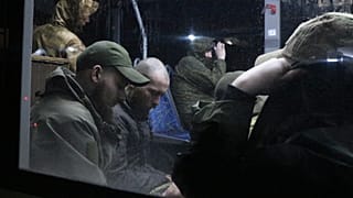 Ukrainian servicemen in a bus after leaving Mariupol's Azovstal steel plant, near a penal colony in Olyonivka, in Donetsk People's Republic territory, Ukraine, May 20, 2022.